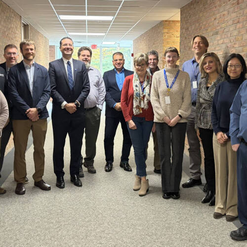 Dean Marouane Kessentini and others from the College of Computing pose with colleagues from Muskegon Community College after discussing articulation agreements.
